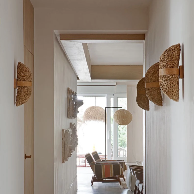 Sustainable hand-made organic fiber water hyacinth wall light enhancing air-pure aesthetics in a home hallway.
