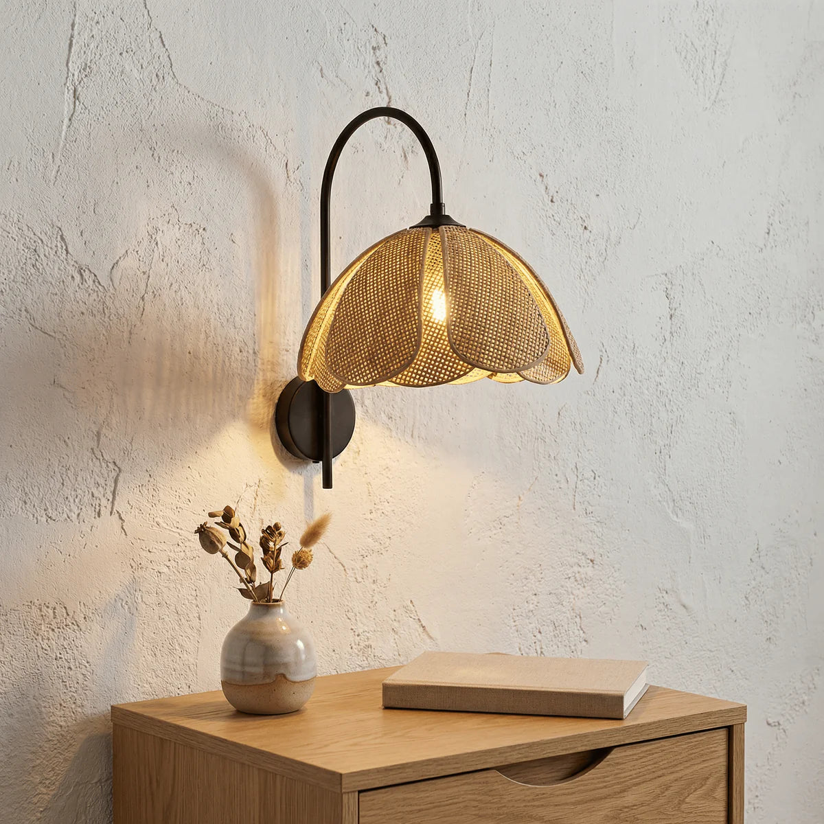 Artisan rattan curved wall light providing eco-conscious natural bedroom lighting