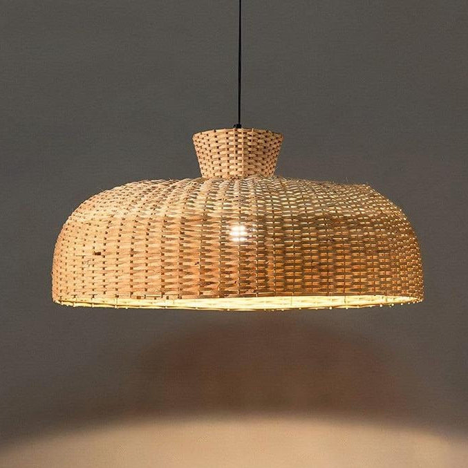 Ethically sourced drop light with rattan dome weave, creating a pure atmosphere in the bedroom.