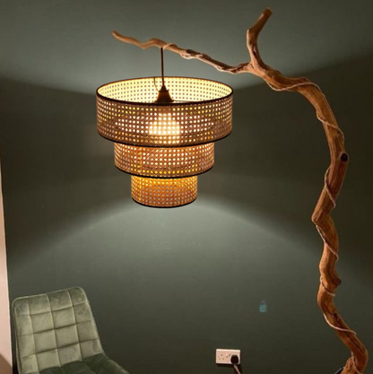 Hanging tiered rattan light fixture for cozy living room atmosphere.