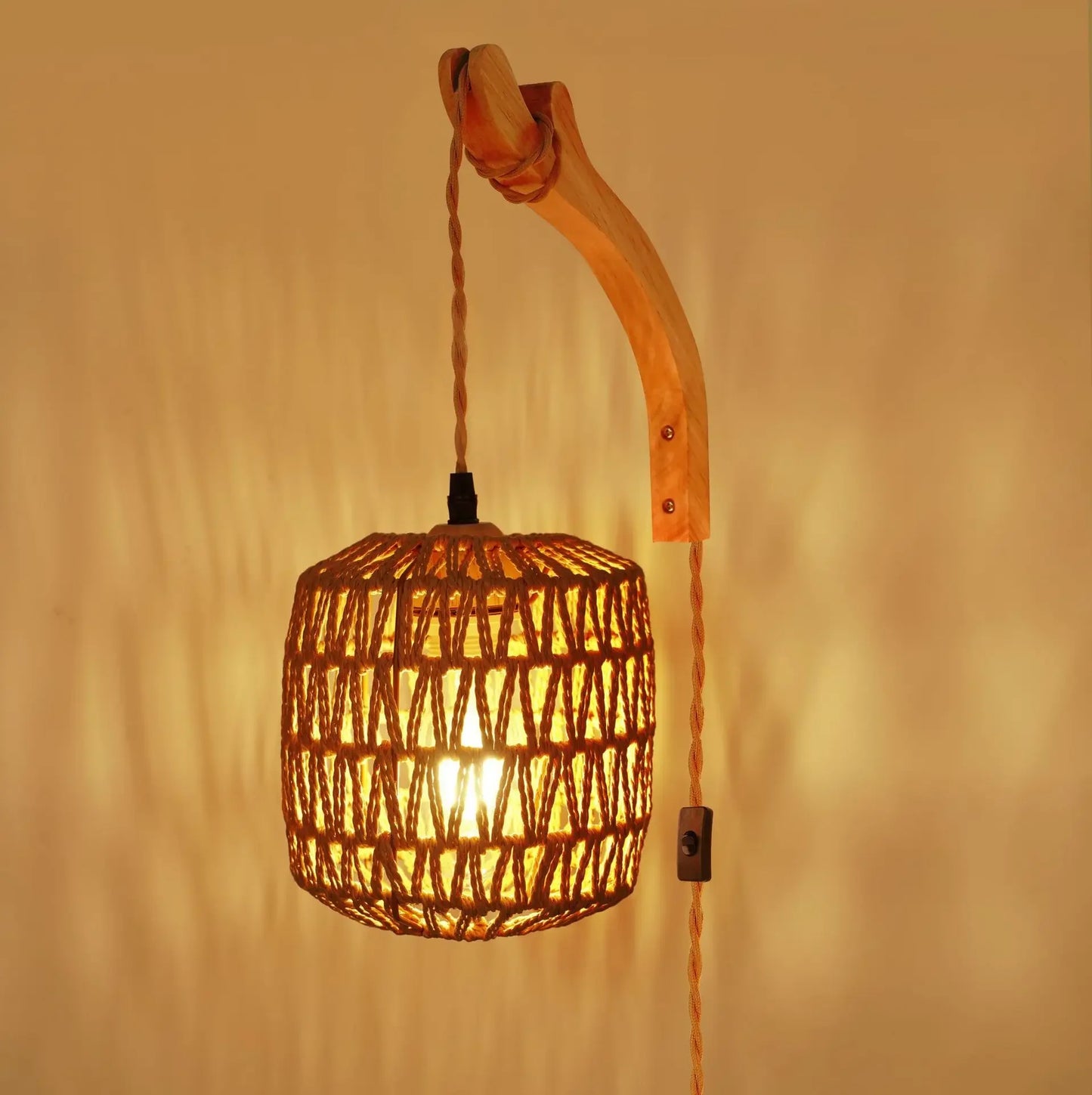 Woven pendant light with wooden arm against a warm beige background