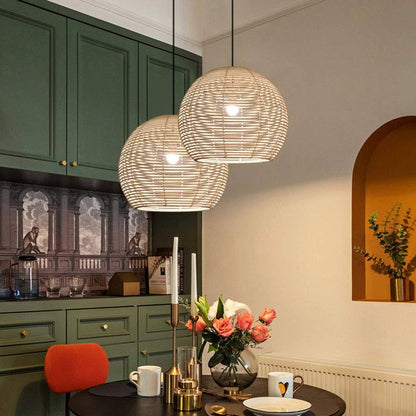 Three-piece set of handwoven rattan globe pendant lights in a warm interior