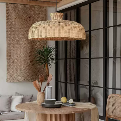 Japandi style hanging lamp with sculptural rattan weave, hanging beautifully over a dining table.