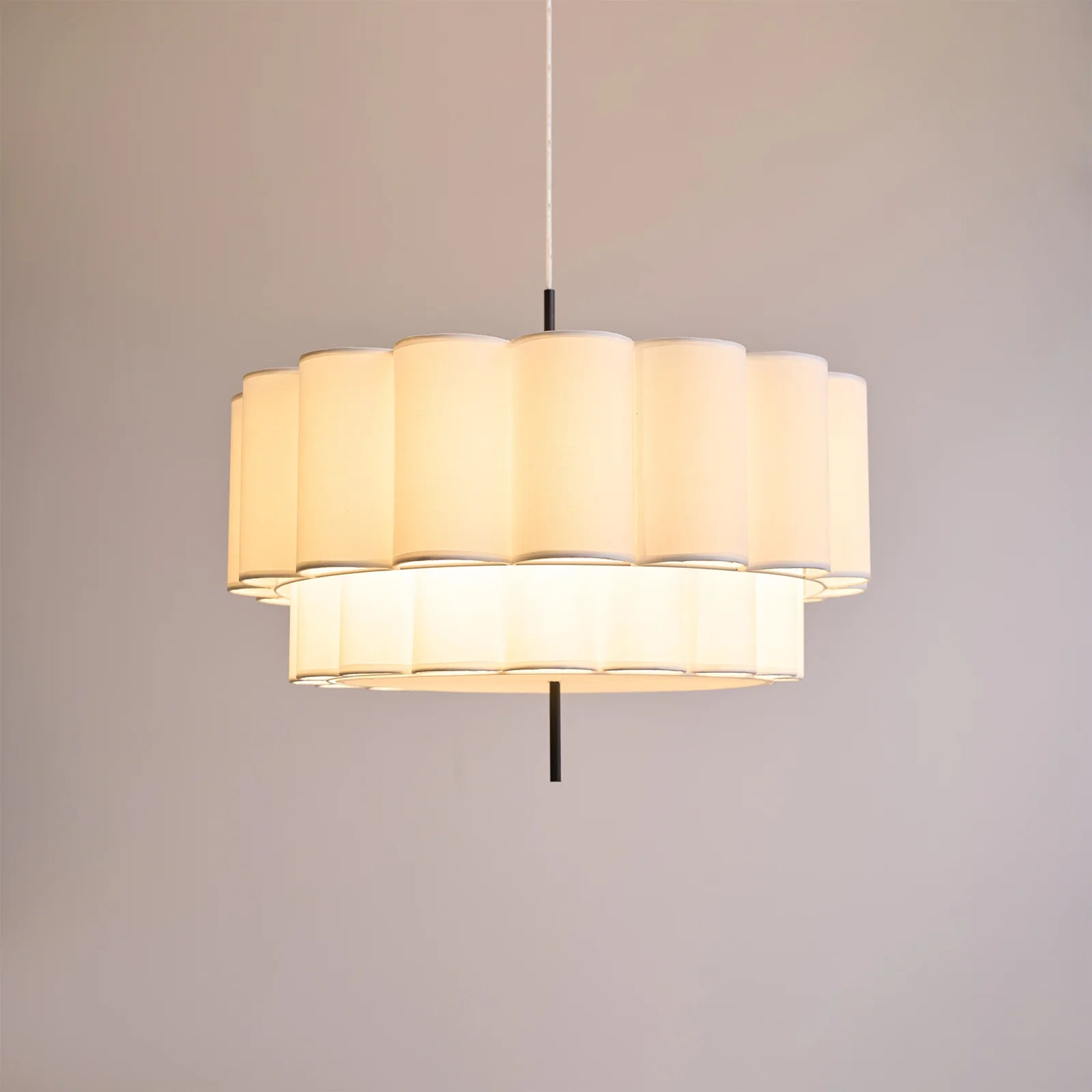 Hanging lamp with natural fabric texture, perfect for art rooms, providing gentle mood lighting for creative spaces.
