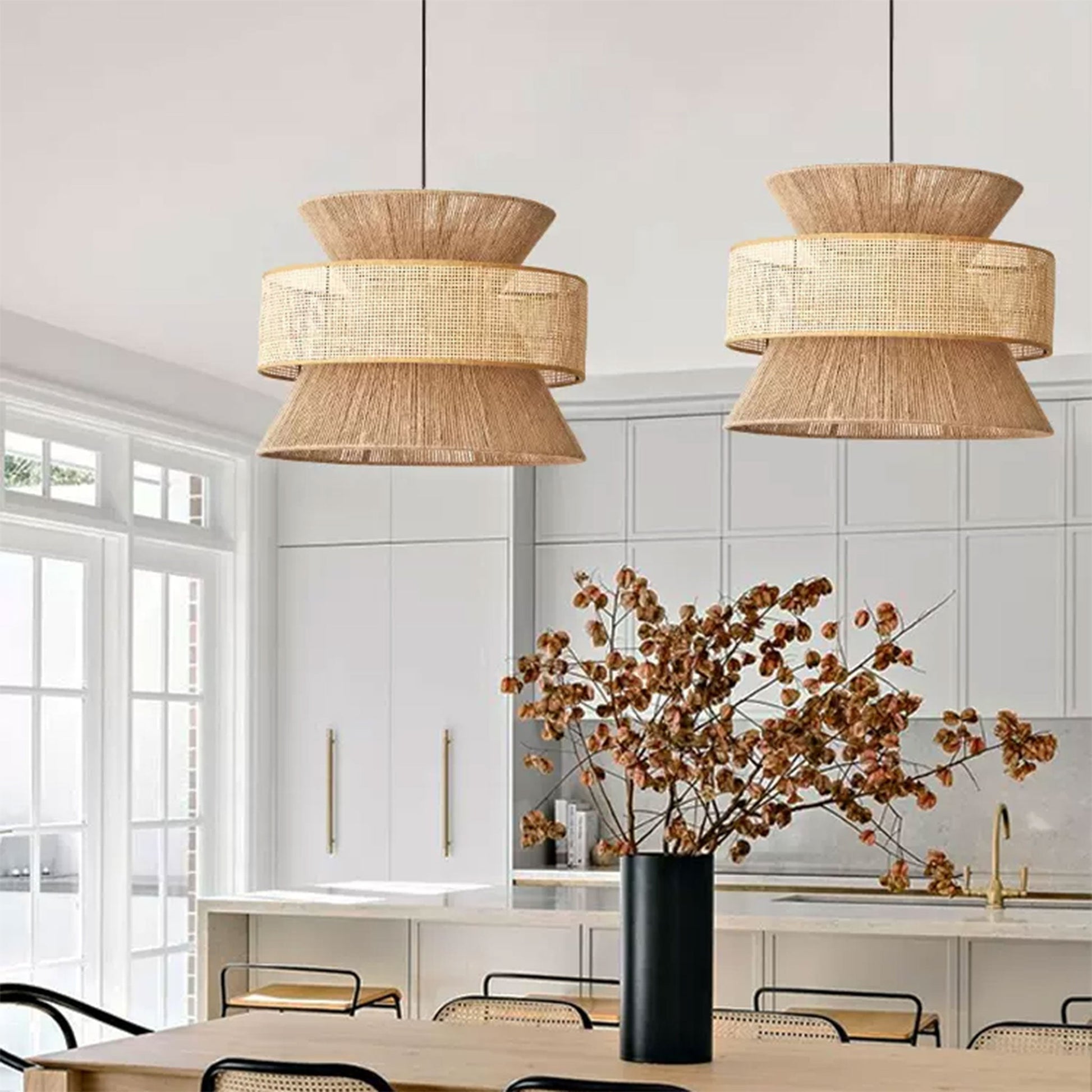 Large statement tiered wicker chandelier styled perfectly in a warm organic modern kitchen with rich wooden cabinetry.