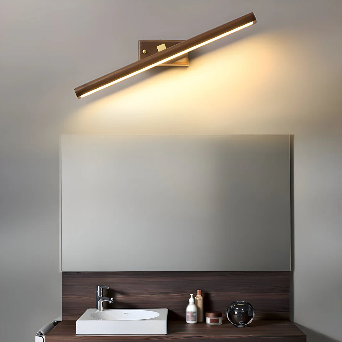 Bathroom vanity with mirror, sink, and wall-mounted light fixture.