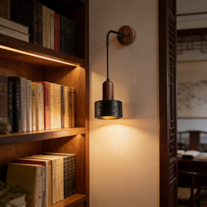 Eco-friendly hand-assembled botanical wood and stone sconce bringing pure natural textures to a cozy reading corner.