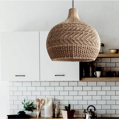 Natural rattan hanging lamp installed over a modern kitchen island