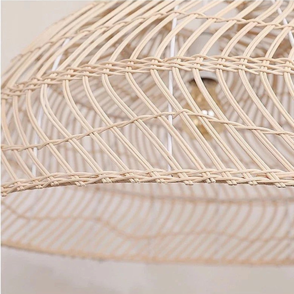 Large rattan basket pendant light in a deep bowl shape casting an elegant lattice pattern glow into the room.