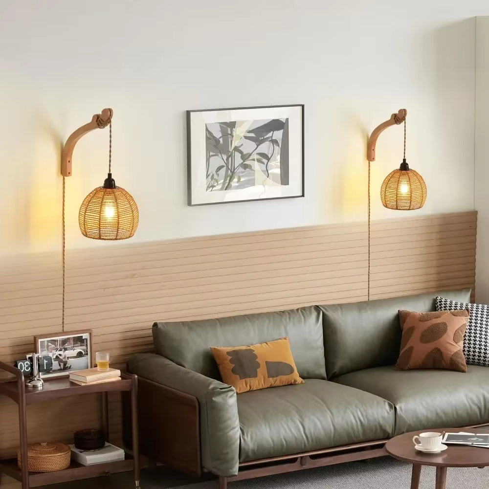 Modern living room with a gray sofa, wooden side table, and wall-mounted lamps.