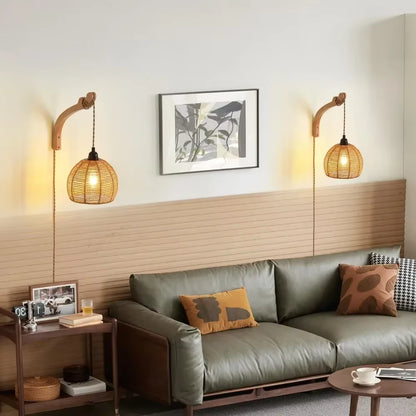 Modern living room with a gray sofa, wooden side table, and wall-mounted lamps.