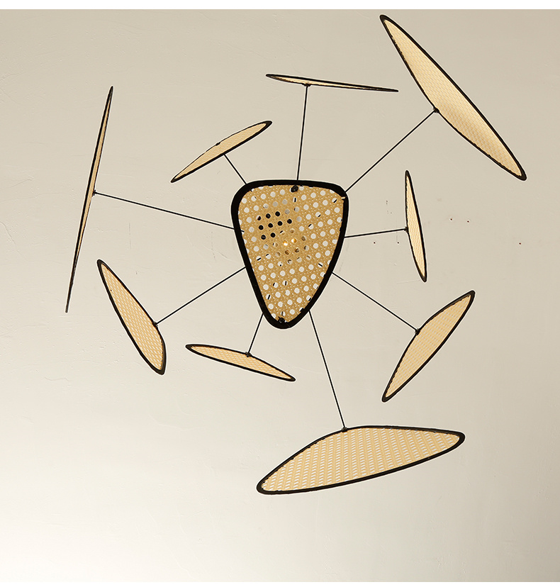 Large boho wicker chandelier with woven cane panels casting soft ambient light over a contemporary dining area.