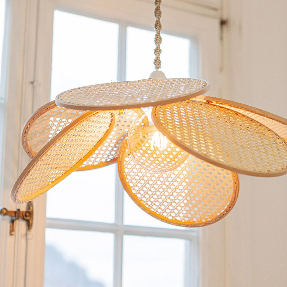 Modern Japandi rattan bloom pendant featuring a unique flower-shaped design with round cane mesh panels.
