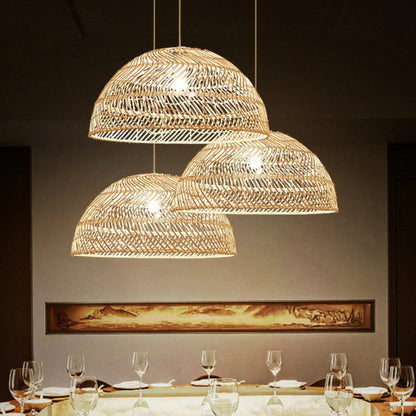 Multi-light bamboo pendant set creating a cozy atmosphere with detailed basketry over a contemporary dining space