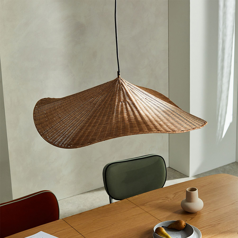 Organic botanical wicker and glass globe light, enhancing healthy indoor climate with natural materials.