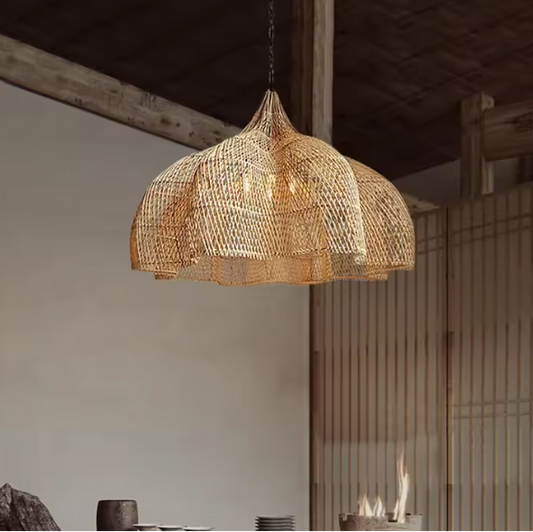 Large flared dome straw hanging lamp displaying a beautiful undulating scalloped rim and warm inner lighting.