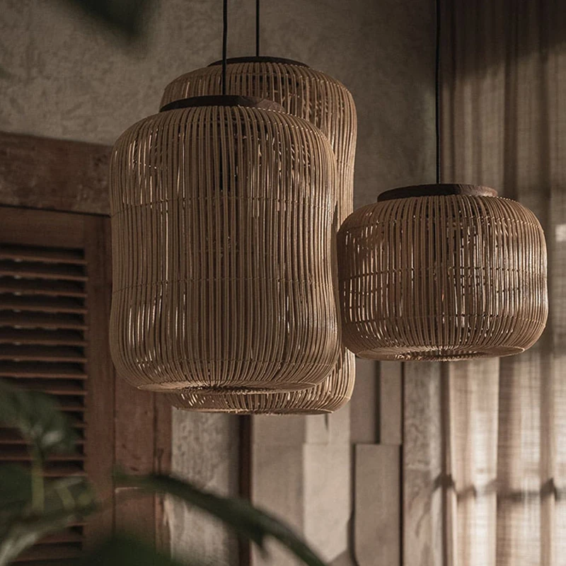 Sustainable organic wicker chandelier with a cluster of three cylindrical hanging shades in matte black.