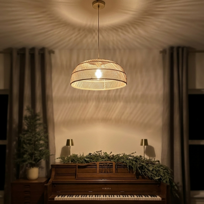 Elegant rattan hanging light fixture illuminating a classic piano room