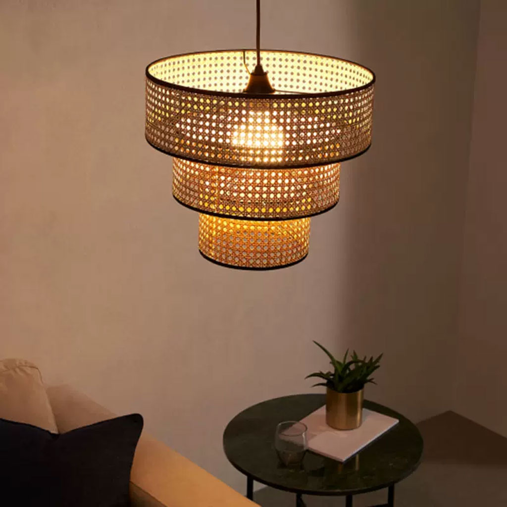 Decorative 3-tier wicker ceiling light with warm ambient glow.