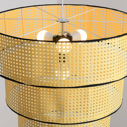 Elegant three-tier rattan pendant light for bedroom interior decor.