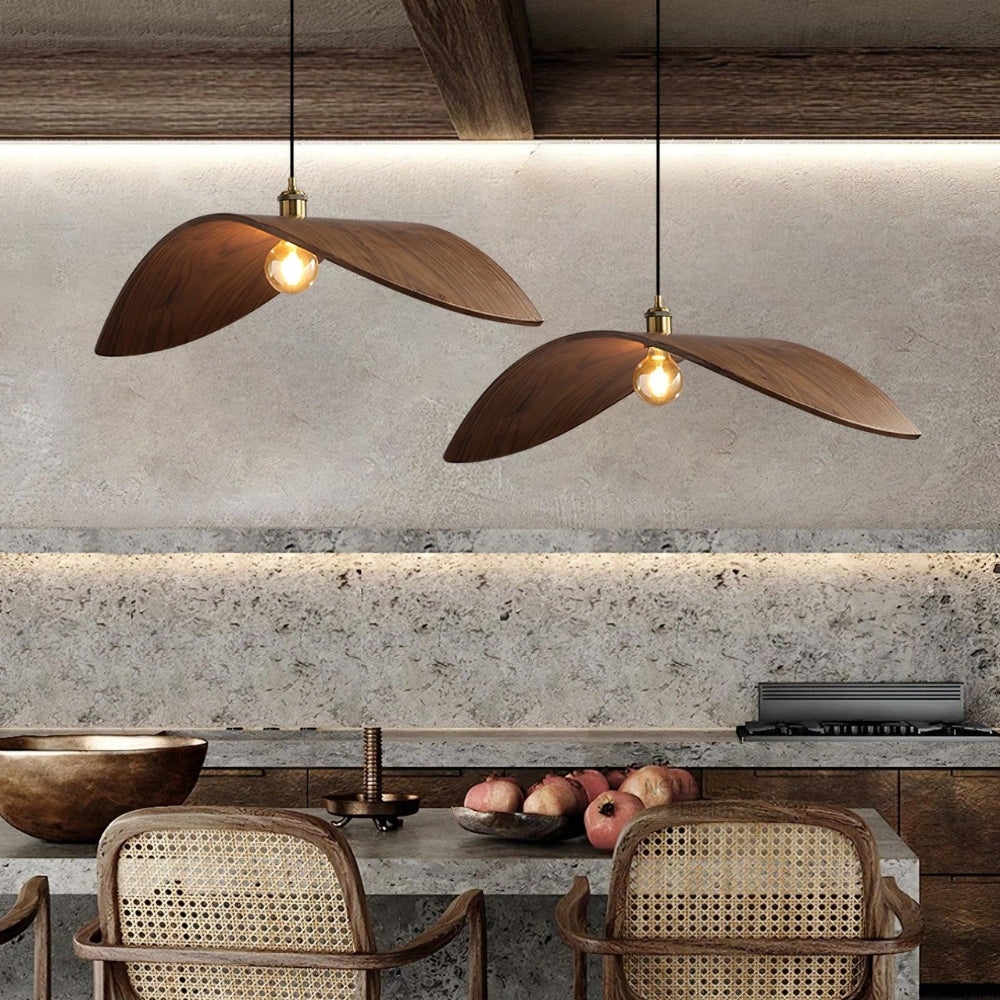 Unique curved wood pendant light illuminating a minimalist dining area