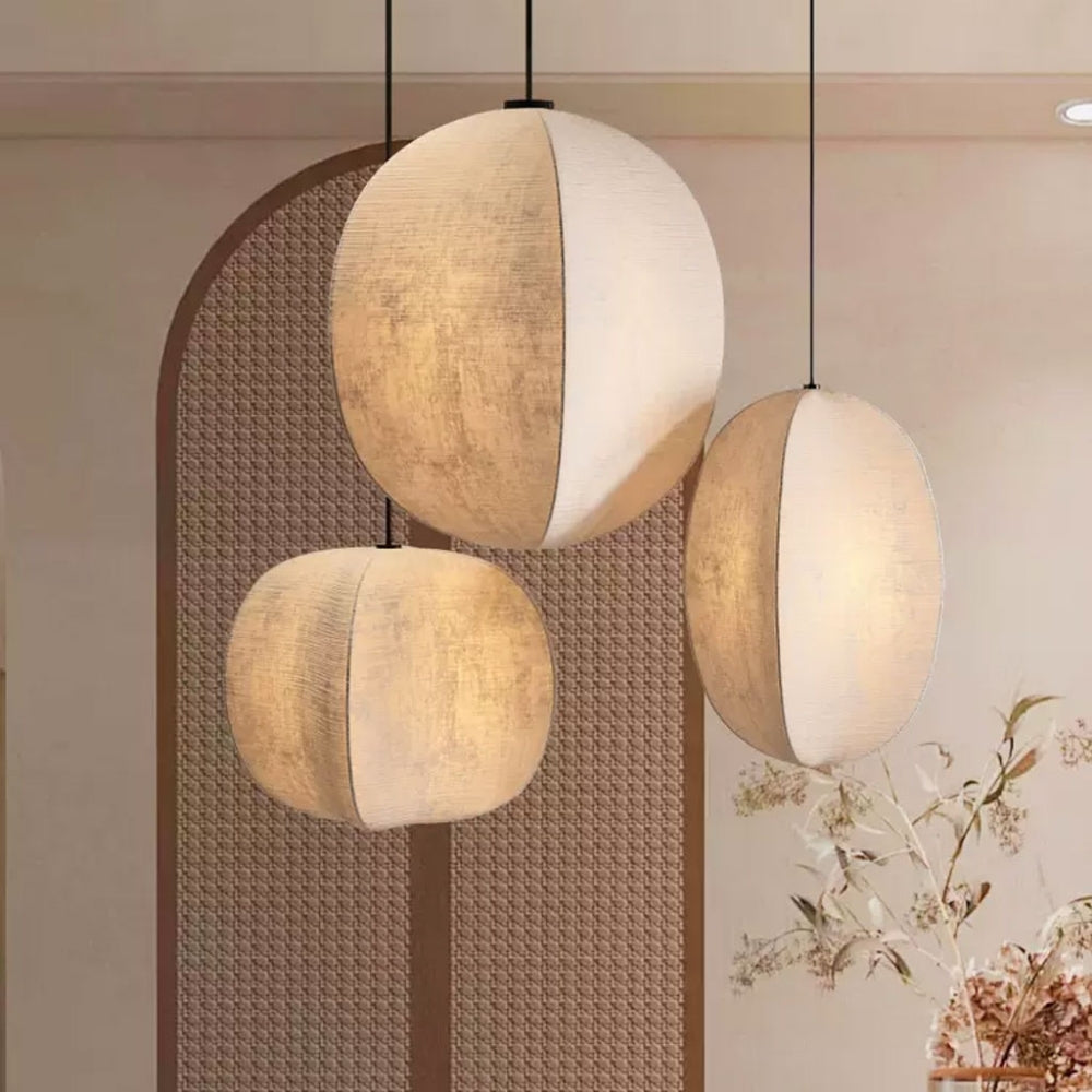 Three round handmade paper pendant lamps with Wabi-Sabi texture