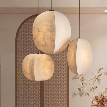 Three round handmade paper pendant lamps with Wabi-Sabi texture