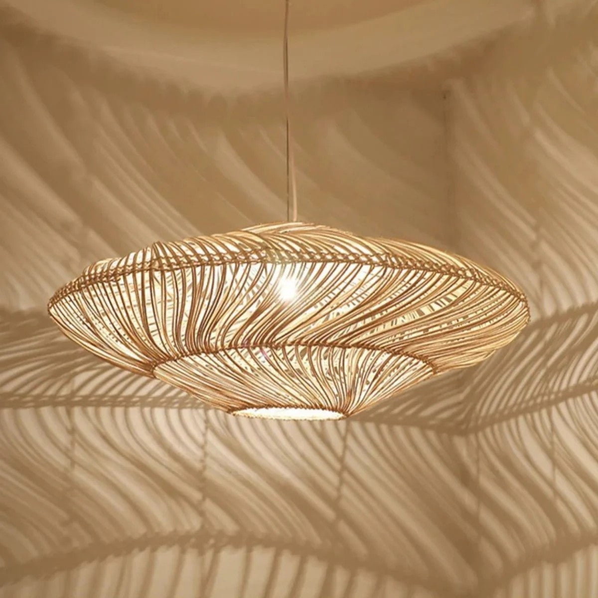 Two Wabi-Sabi wicker pendant lights hanging at different heights, emitting a warm glow against a neutral wall