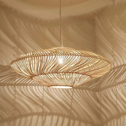 Two Wabi-Sabi wicker pendant lights hanging at different heights, emitting a warm glow against a neutral wall