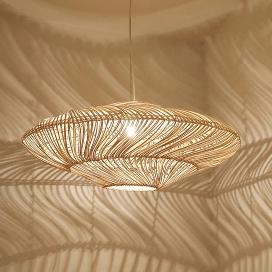 Two Wabi-Sabi wicker pendant lights hanging at different heights, emitting a warm glow against a neutral wall