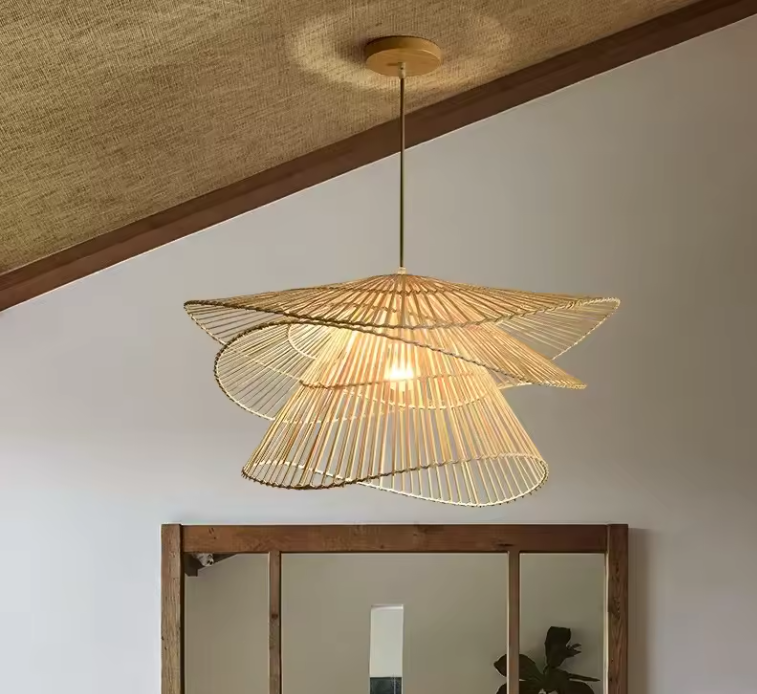 Wabi-Sabi woven chandelier casting a warm, ambient glow above a wooden framed mirror.