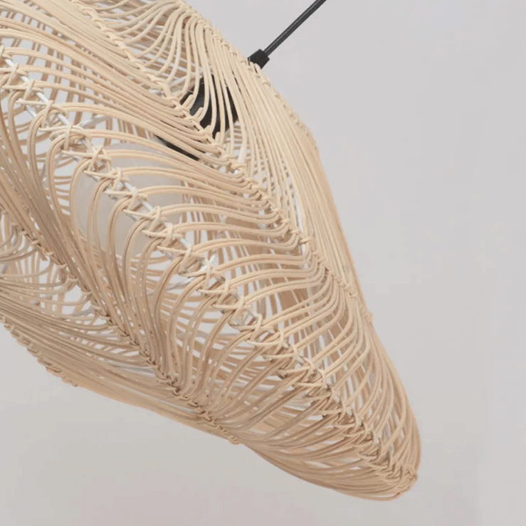 Two contemporary wicker light fixtures with an elegant wave silhouette against a clean plain background.