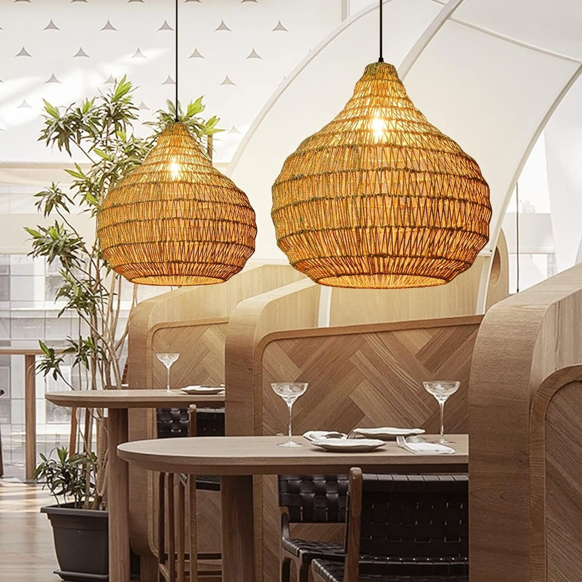 Artisan handwoven seagrass bell pendant light creating a sophisticated and warm ambiance for restaurant dining areas