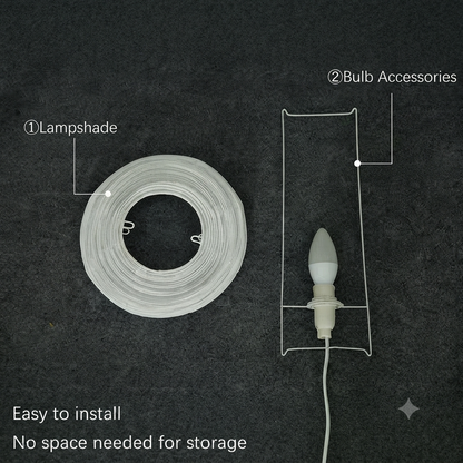 A coiled white lampshade on a dark textured background next to a bulb accessory holder with a white bulb, with text labels pointing to the lampshade and bulb accessories.