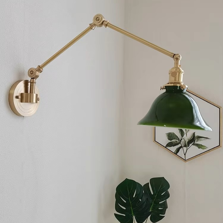 Elegant brass swing-arm wall light with a classic white ceramic shade offering refined charm for a welcoming entryway.