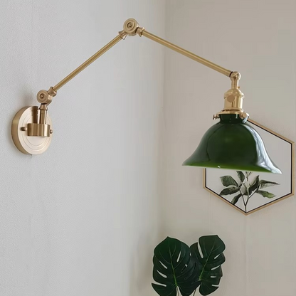 Elegant brass swing-arm wall light with a classic white ceramic shade offering refined charm for a welcoming entryway.