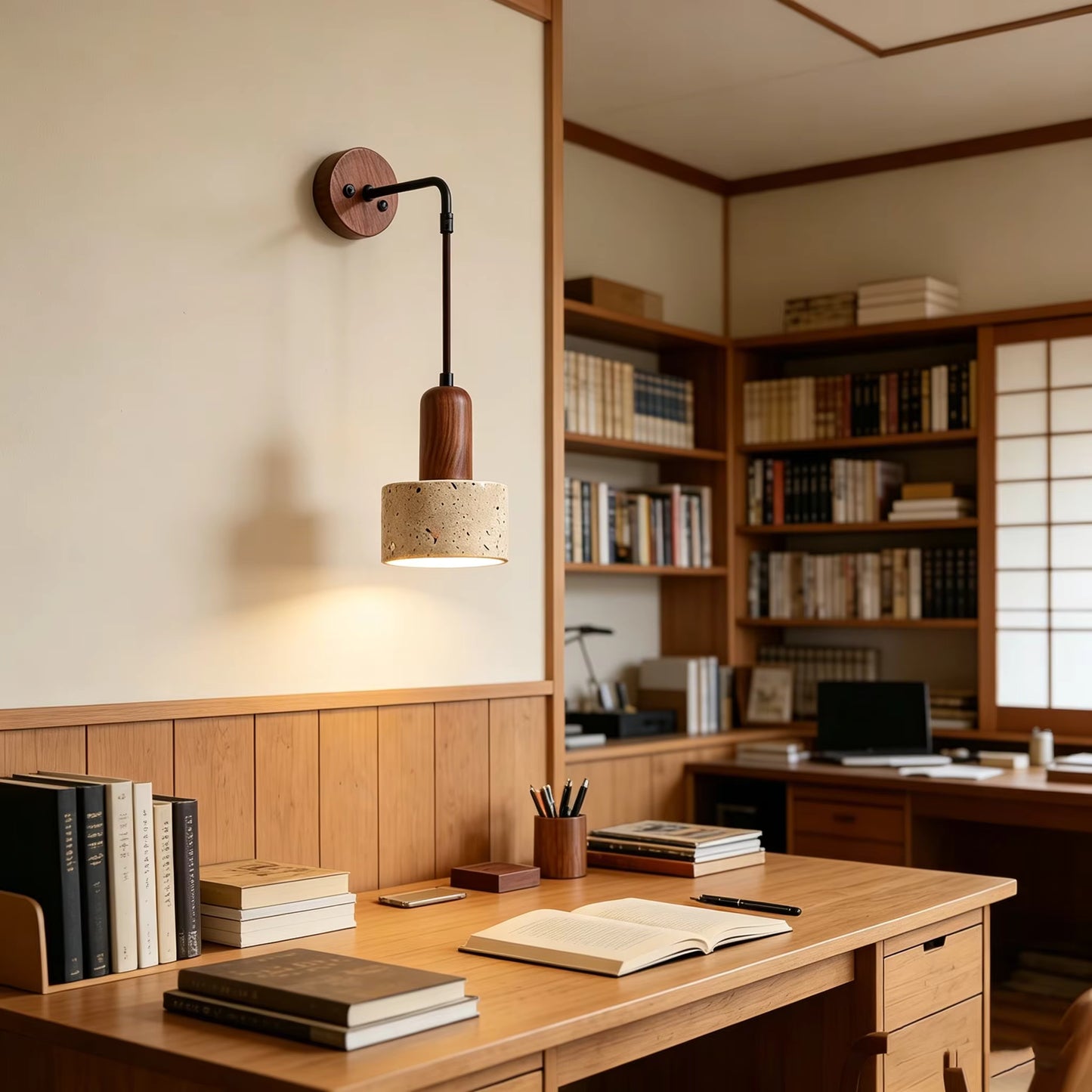 Wooden desk with books and a lamp in a home office setting
