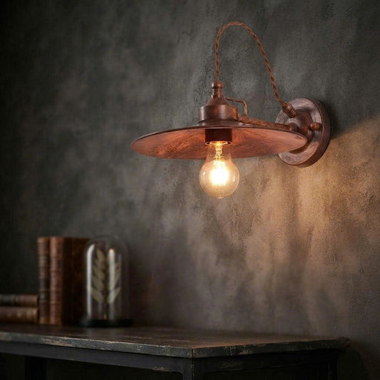 Vintage industrial iron and metal wall sconce crafted from sustainable materials for a rustic living room.