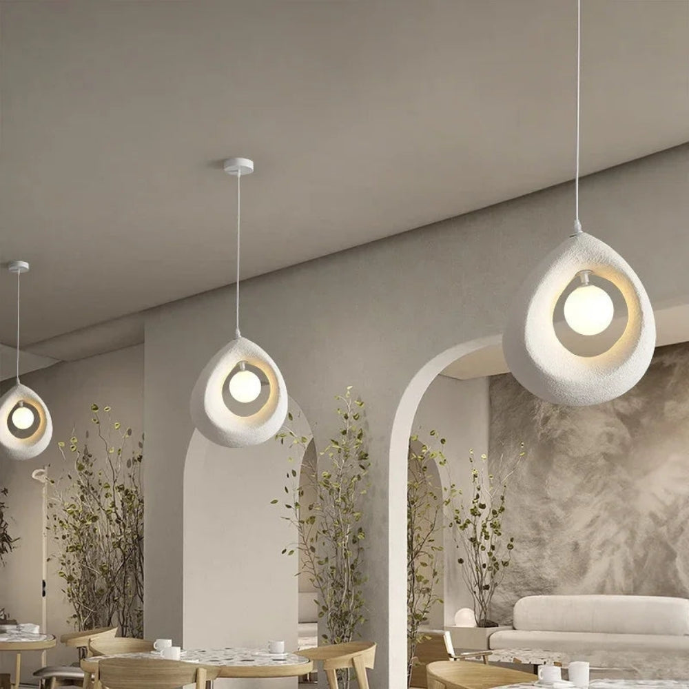 Minimalist pebble-shaped hanging lamp in textured off-white finish