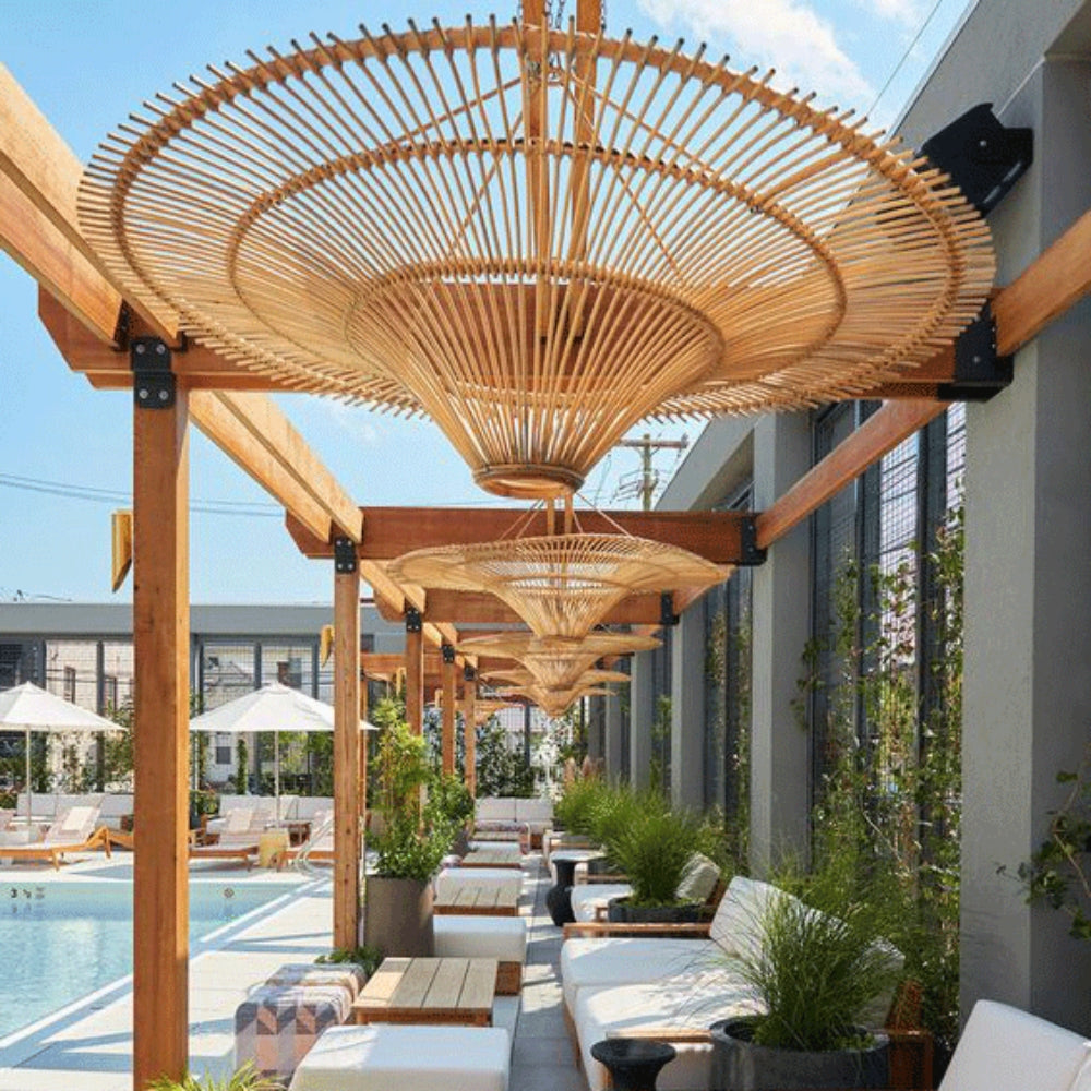 Eco-friendly natural rattan pendant lamp installed in a luxury tropical resort lobby.