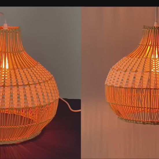 A pair of two-tone rattan pumpkin pendant lights with white and natural woven halves hanging linear-style in a bright modern kitchen.