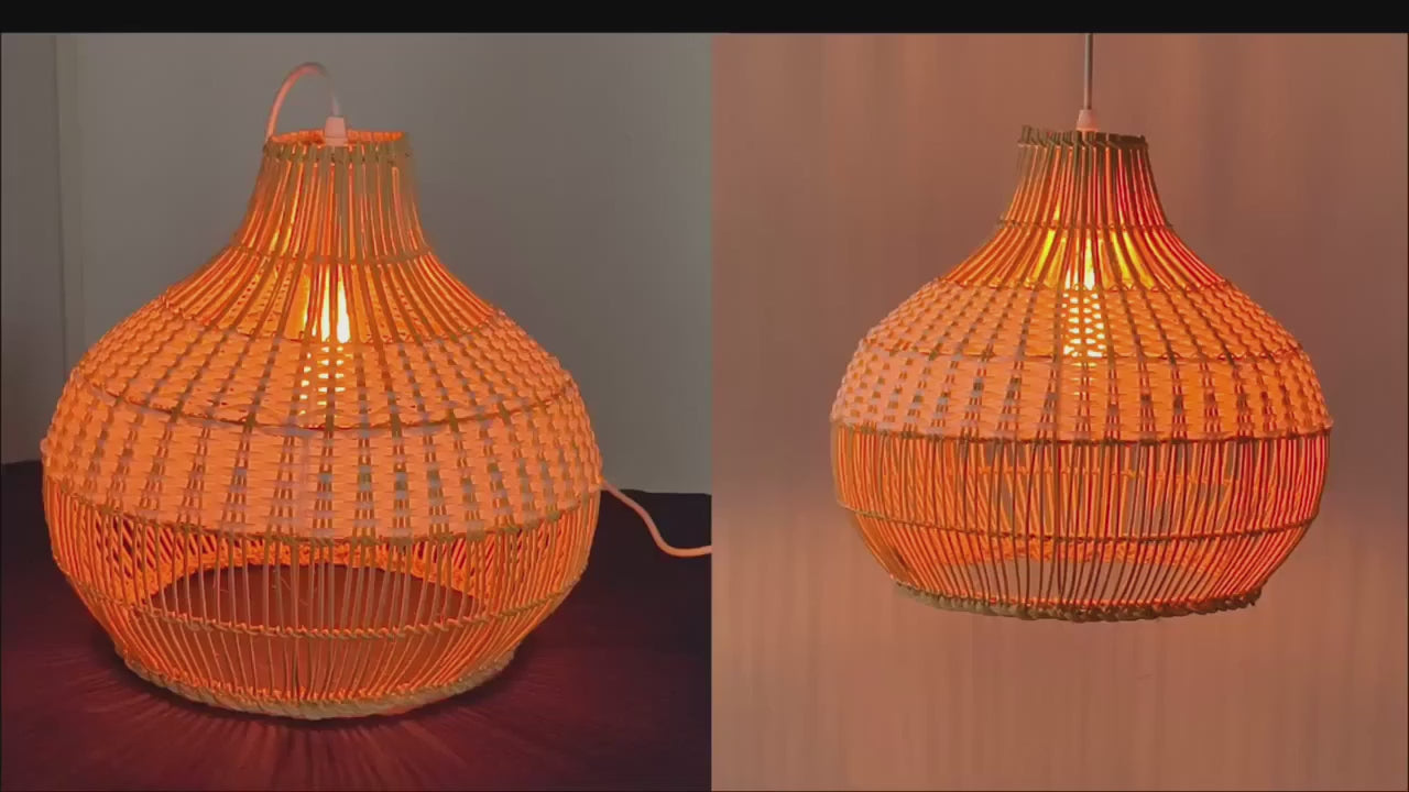 A pair of two-tone rattan pumpkin pendant lights with white and natural woven halves hanging linear-style in a bright modern kitchen.