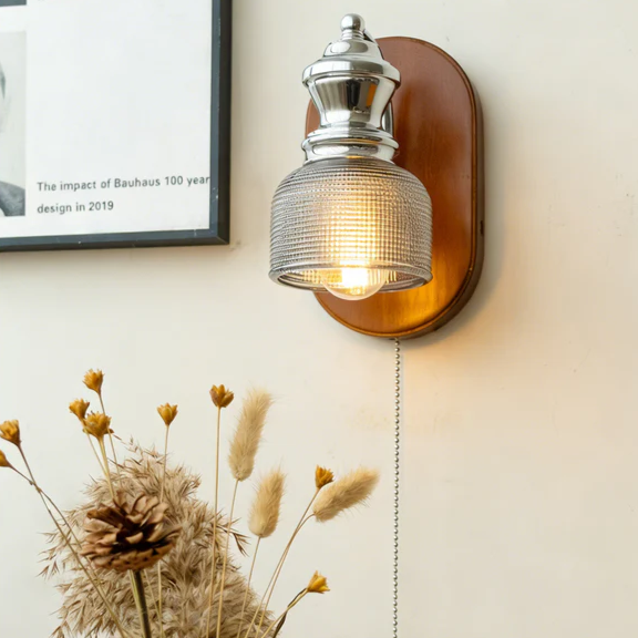 Quiet luxury lighting wood and iron sconce featuring understated elegance for a high-end luxury hotel suite.