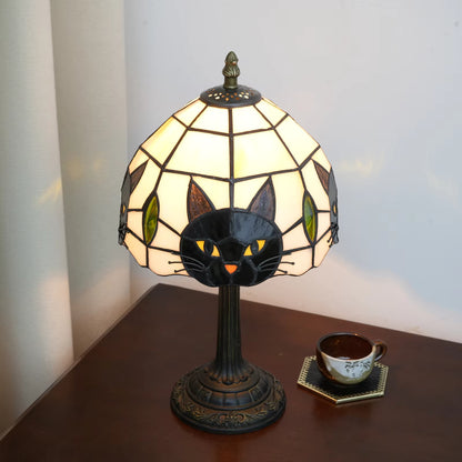 Sustainable lighting decor featuring a handcrafted Tiffany-style stained glass lampshade shaped with a cute black cat design.