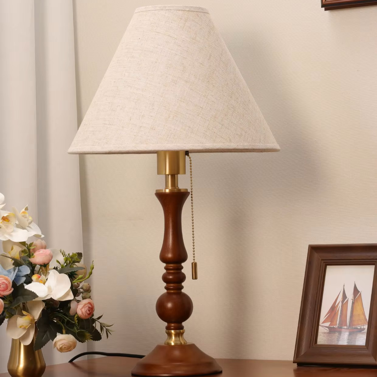 Neoclassic wooden table lamp featuring elegant brass hardware and a fabric shade for upscale hallway console tables.