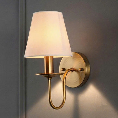 Handmade eco-friendly iron and fabric wall lamp providing safe, health-conscious ambient illumination in a bedroom.