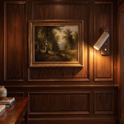 Modern wood and stone wall sconce functioning as a stylish picture light to illuminate art and paintings in a home gallery.